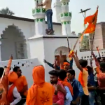 Hindu extremists plant saffron flag on top of a Mosque