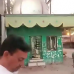 Hindu extremists put up a saffron flag on top of an Islamic shrine