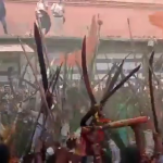 Mob of Hindu right-wing brandishing swords and playing loud music in front of a mosque