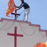 Participants in a far-right rally put a saffron flag on top of a Church amid religious slogans in Jhabua
