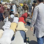 Policeman kicks people offering Friday prayers roadside in New Delhi
