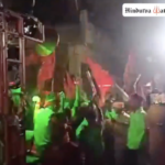 Shobha Yatra participants flash swords while marching through Sherghati town