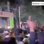 Participants in Shobha Yatra flash swords while dancing to music in Godda